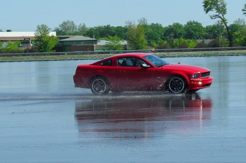 The Red Bullitt is pictured being driven out onto on the wet skidpad by Ford engineer Nick Terzes