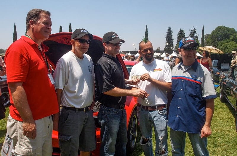 The board of directors of HoonDog Performance Group receives official handoff of the car key for $1 from Ford engineer Shawn Carney