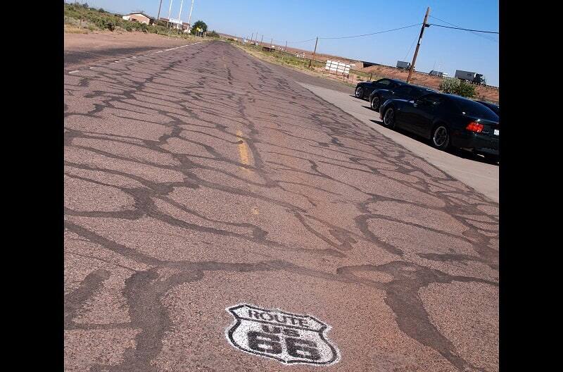 A picture of a painted Route 66 sign on the road