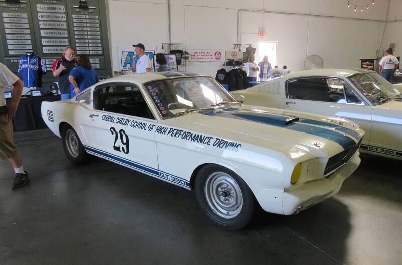 Two classic white Mustangs on display