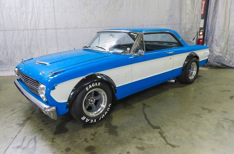 A classic blue and white Ford vehicle on display