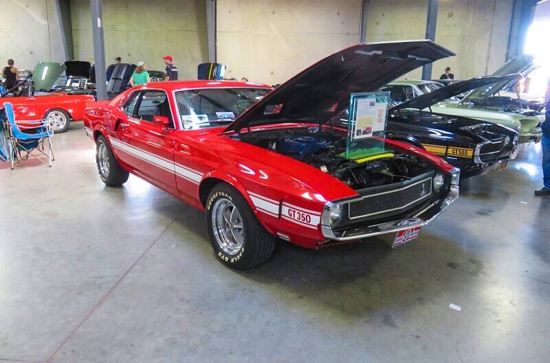 A front side view of a classic red Shelby GT350