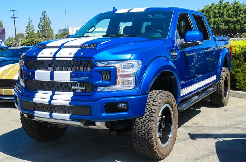A front side view of a blue and white Shelby truck