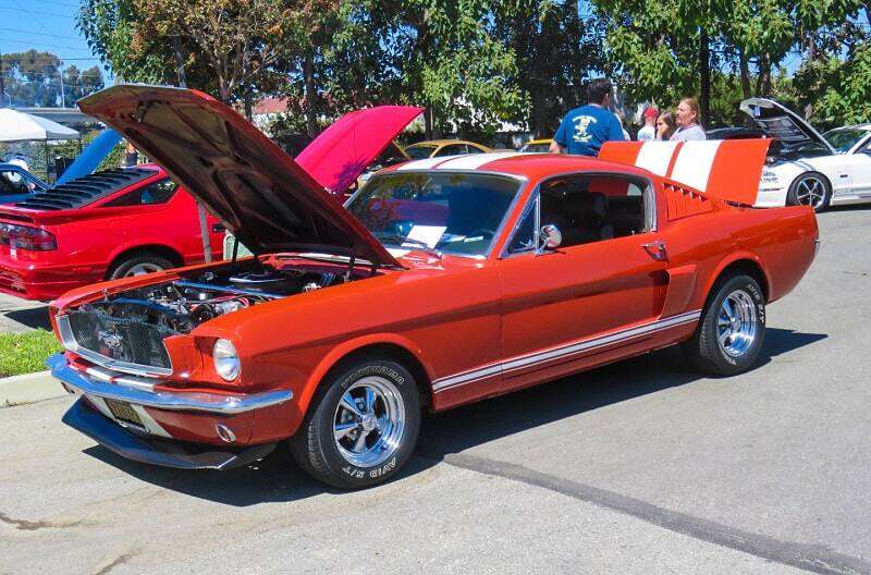 A classic dark orange Mustang on display