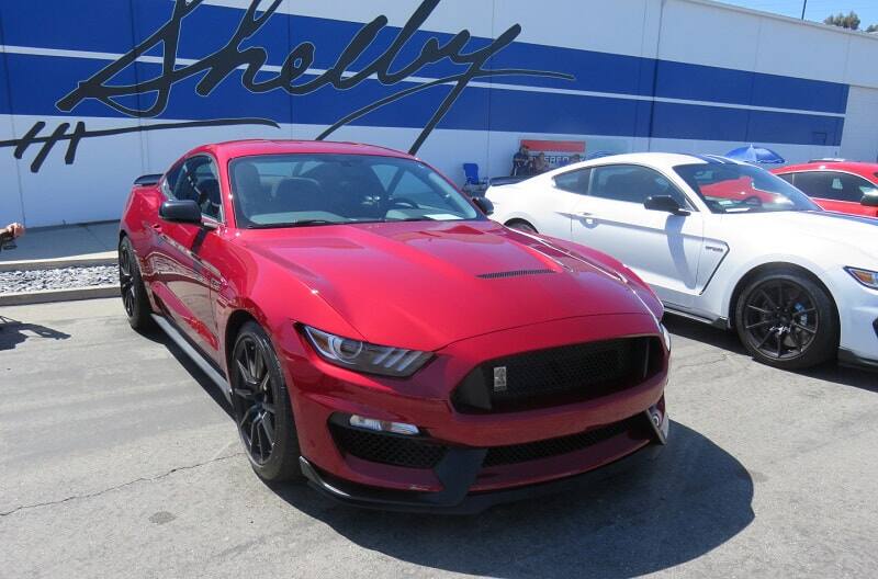 A closeup of a red Shelby Mustang on display