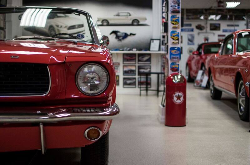 A front end view of a red Ford Mustang on display