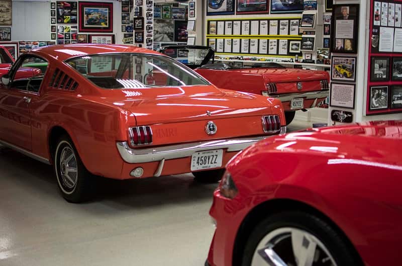 A rear side view of a classic red Mustang