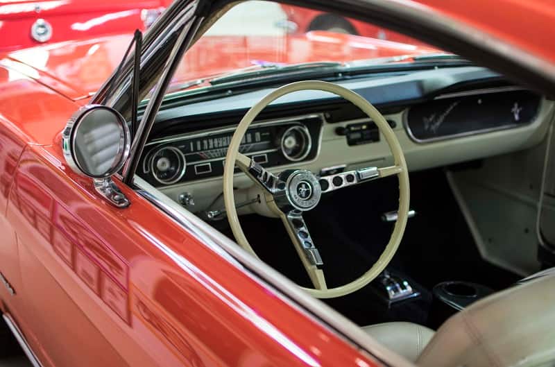 A close look at the driver's side interior of a red Mustang