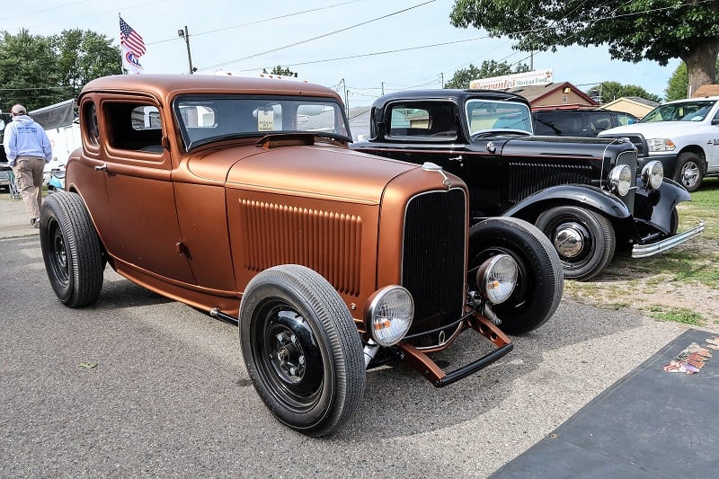 A front side view of a bronze hot rod on display