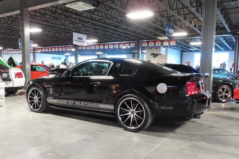 Profile of black GT Mustang parked in garage