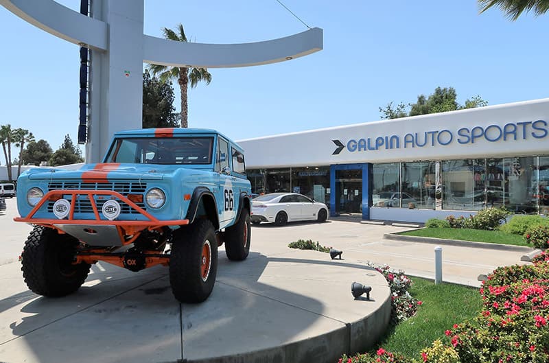 A blue and orange Ford Bronco on display outside Galpin Auto Sports