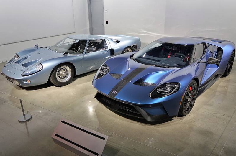 A light blue and a dark blue Ford GT on display in the museum