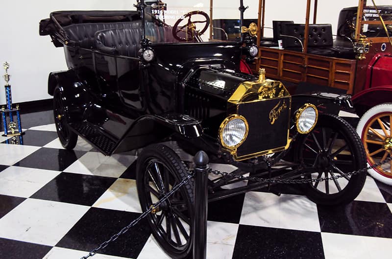 A front side view of a classic black vehicle on display