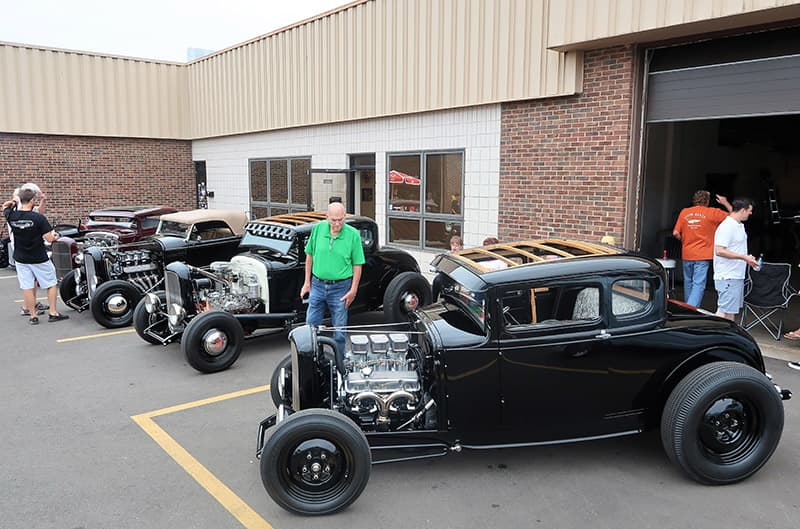 Various black classic Fords parked in lot