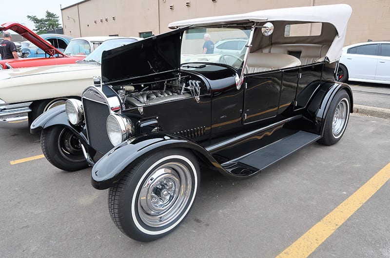 Profile of a black classic Ford in parking lot