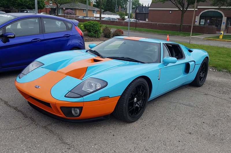 Front of a blue and orange Heritage GT in parking lot