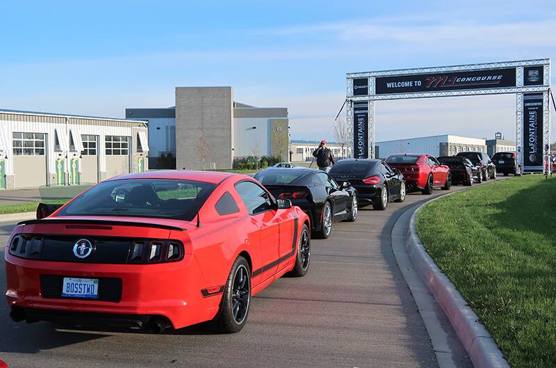 A rear end view of a red Mustang on display