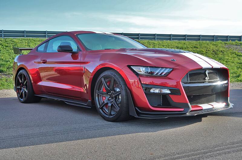 A front side view of a red Shelby Mustang on display