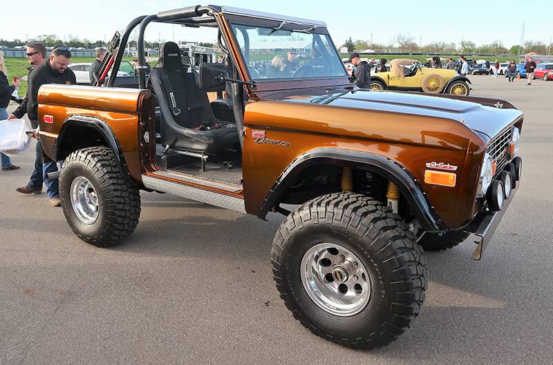 A side view of an orange Ford Bronco on display