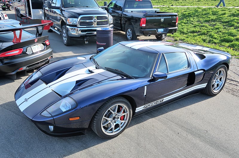 A front side view of a blue Ford GT on display