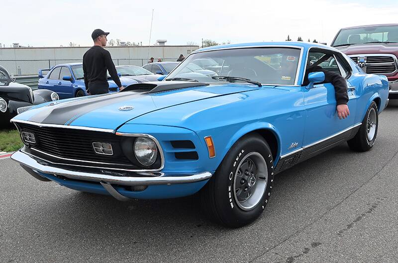 A front side view of a classic blue Mustang