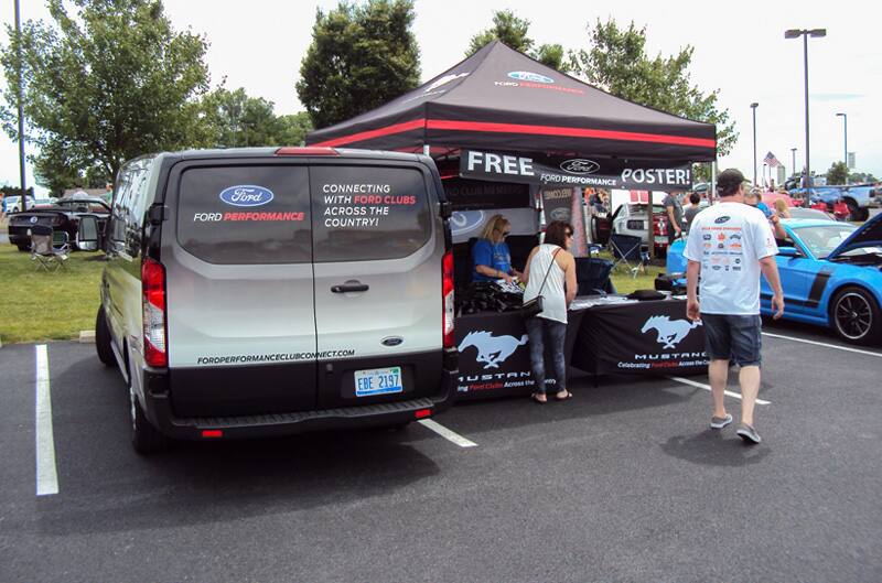 Ford Performance promotions tent next to Ford Performance transit van in the parking lot