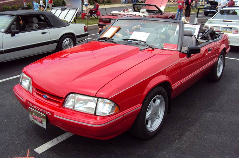 Front of a red Mustang convertible in the parking lot