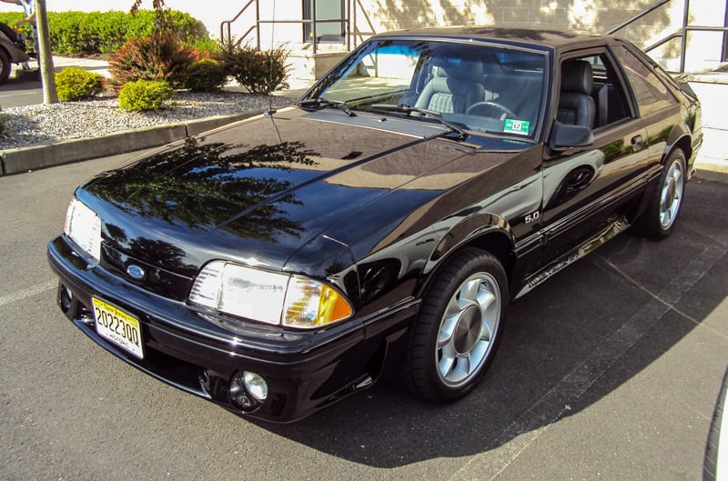 Front of a black Mustang in parking lot