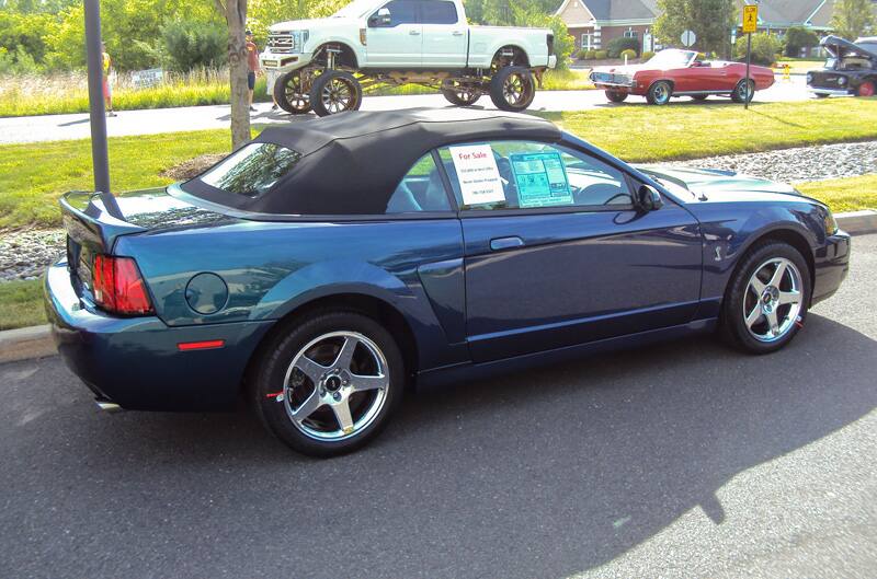 Profile of a blue Shelby droptop in parking lot