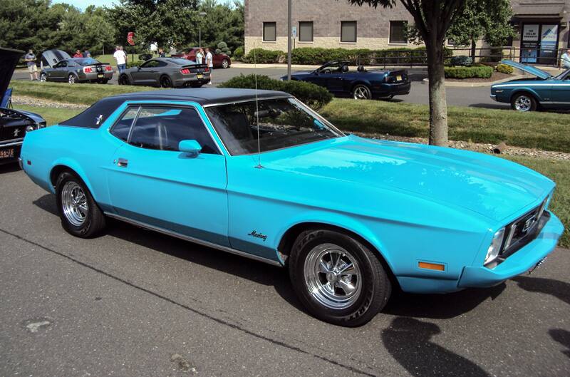 Profile of a teal blue Mustang in the parking lot