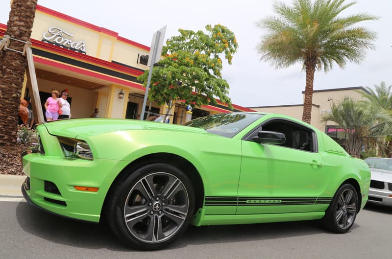 Profile of a lime green Mustang in the parking lot