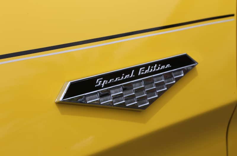 Close up of a special edition stamp on a yellow Mustang