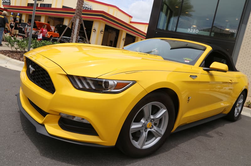 Front profile of a yellow Mustang in the parking lot
