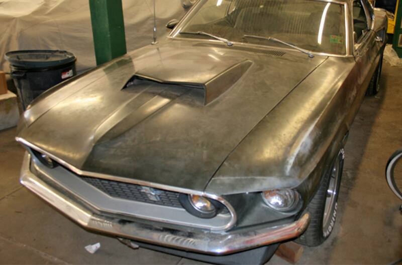 Close up front of dusted black Mustang Boss 429 in garage