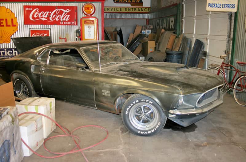 Front profile of dusted black Mustang Boss 429 in a garage