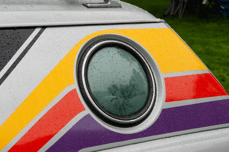 A closeup of a headlight on a classic Ford vehicle