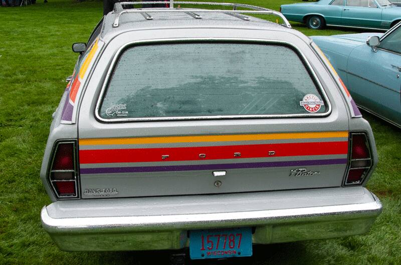 A rear end view of a classic Ford vehicle on display