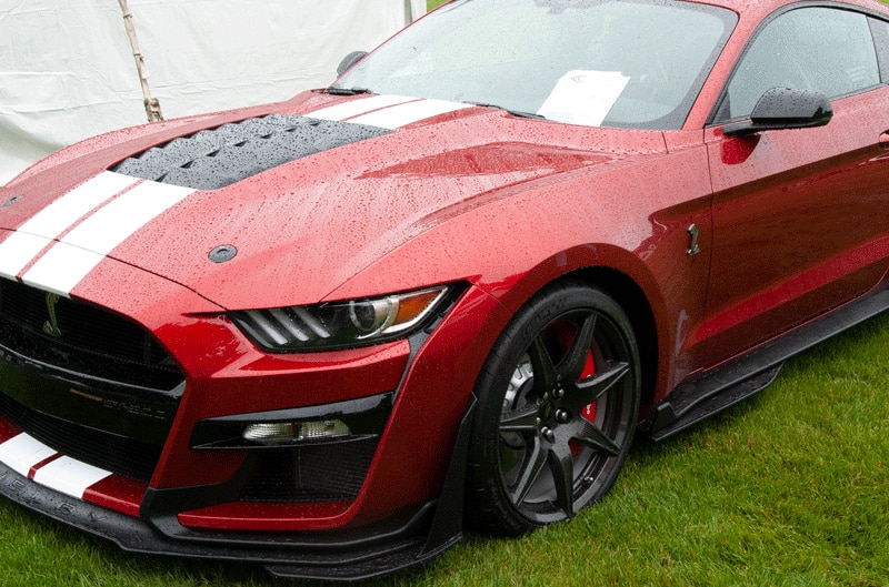 A front side view of a red Shelby Mustang on display