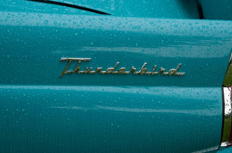 A closeup of the Thunderbird insignia on the side of a classic vehicle