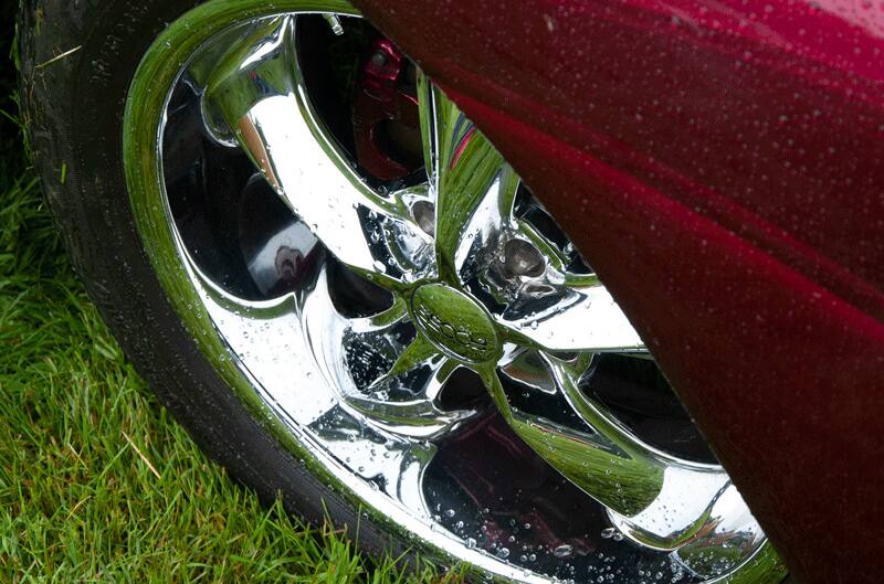 A closeup of a wheel on a classic vehicle