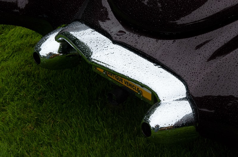 A closeup of the rear end of a classic black vehicle