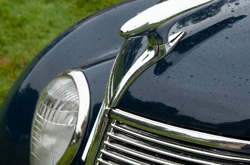 The side view of the front bumper of a classic black vehicle