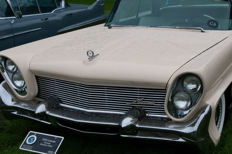 A closeup of the front end of a 1958 Lincoln on display
