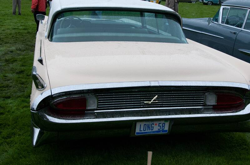 A rear end view of a classic vehicle on display