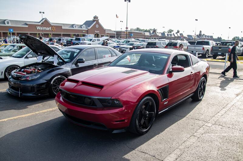 A front side view of red Mustang on display