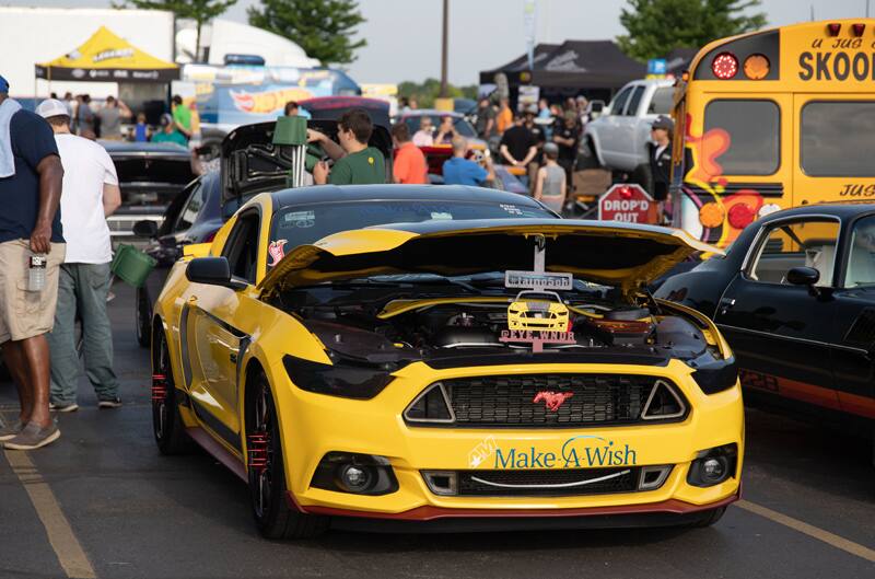 A yellow Mustang on display