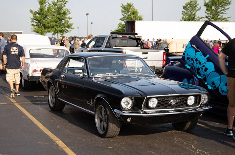 A classic black Mustang on display