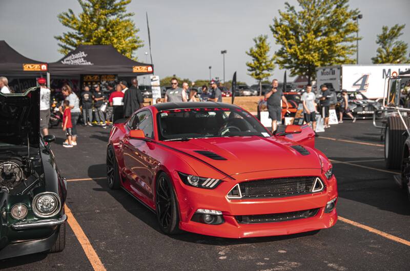 A front side view of red Mustang on display