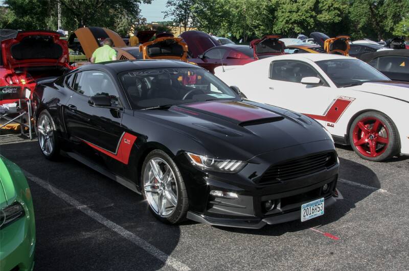 A black and red Mustang on display