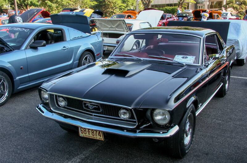 A classic black Mustang on display